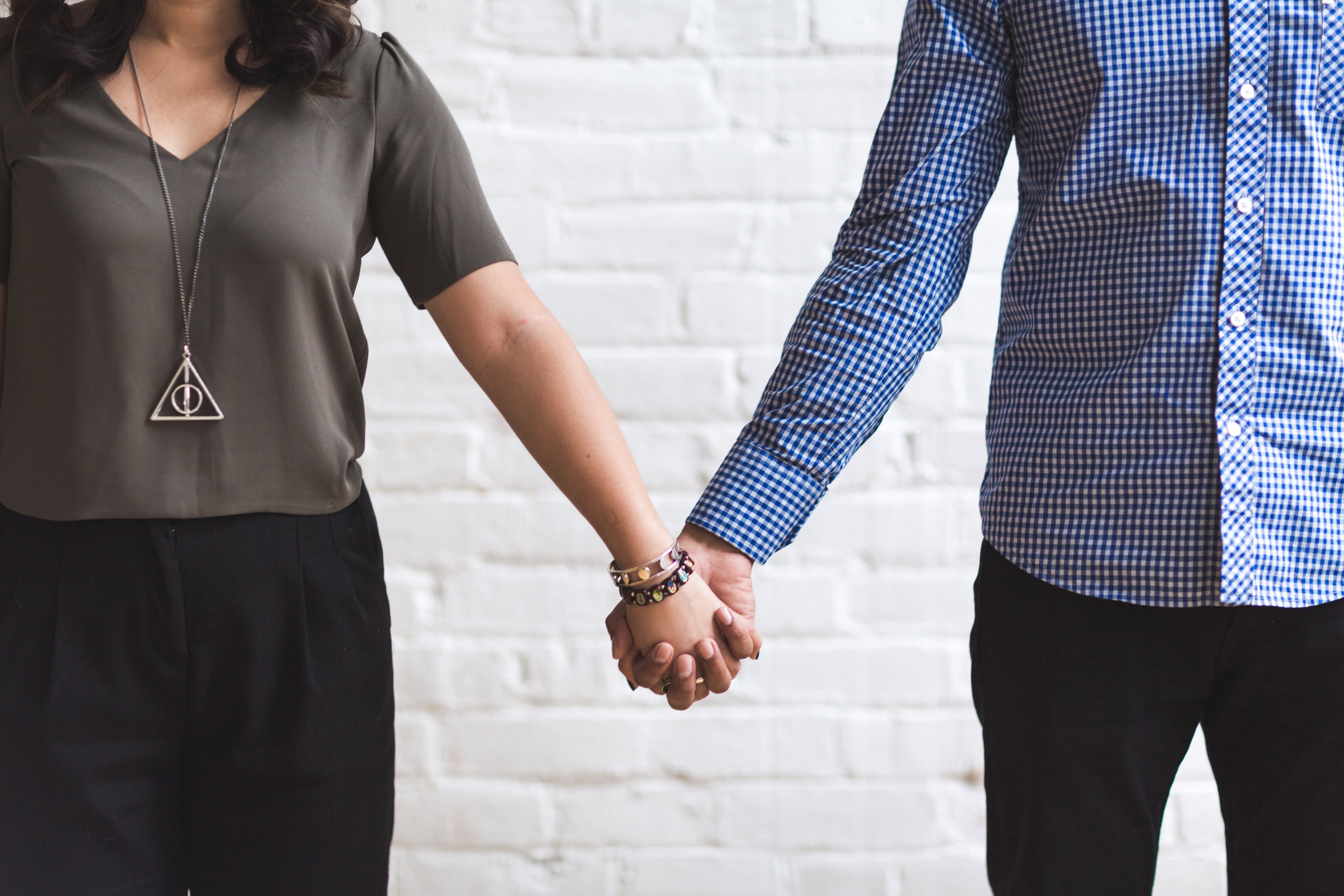 Couple holding hands, representing connection and partnership